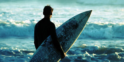 Surfer along the shore