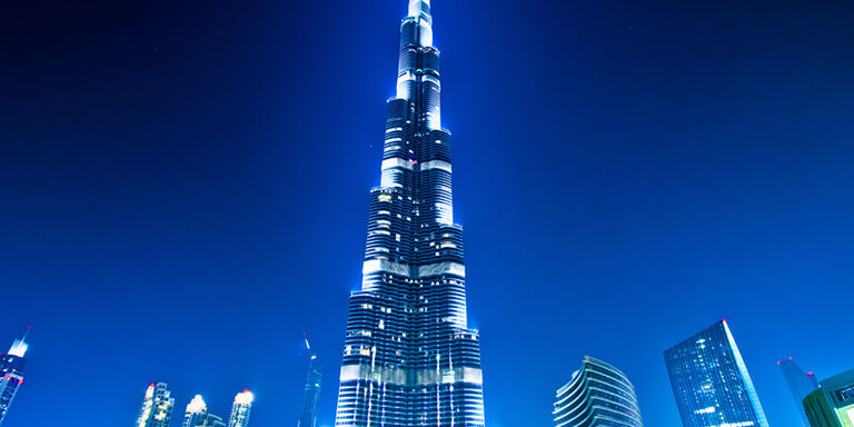 A blue glow frames the Burj Khalifa