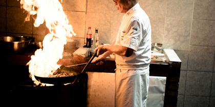 A chef preparing food at Chez Wong