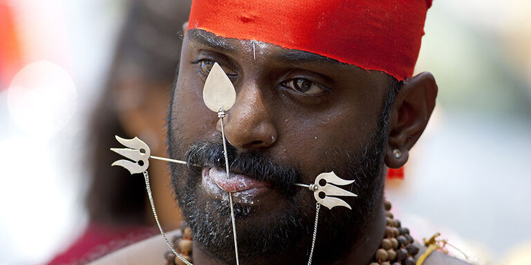 A kavadi pierces the tongue and cheeks