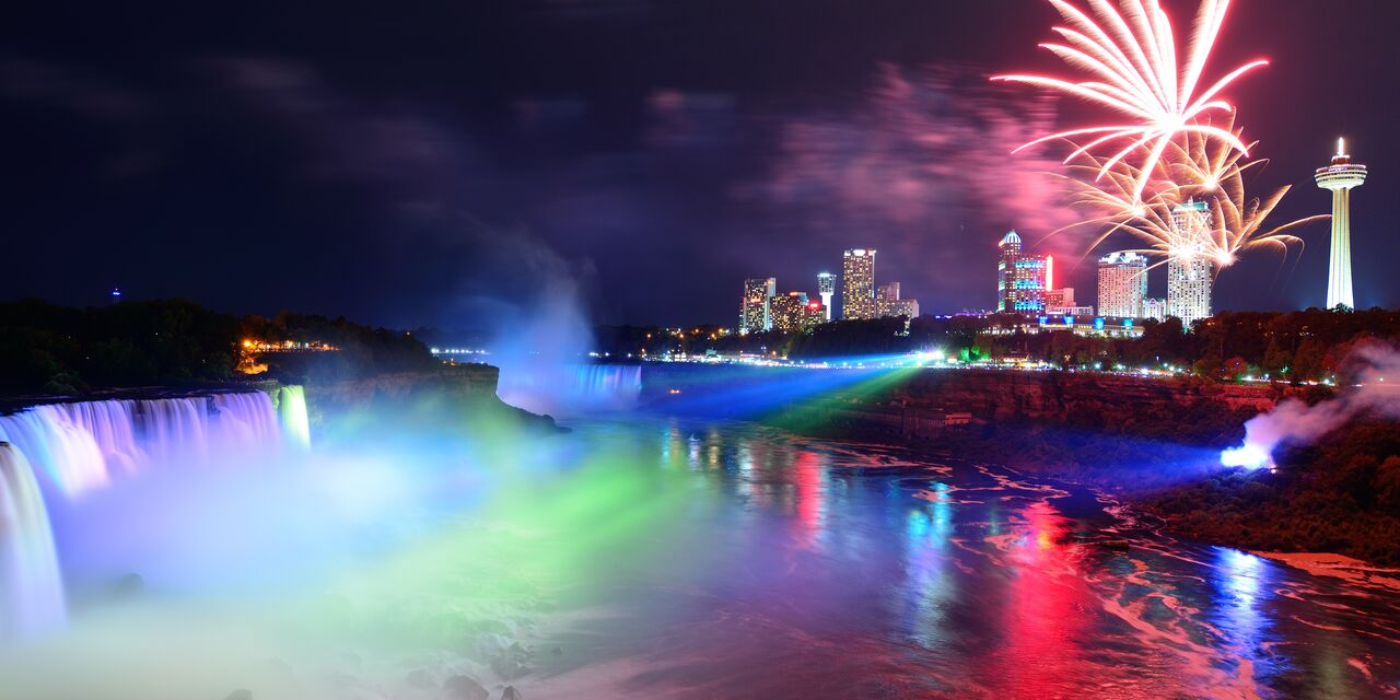 Niagara Falls lit up with a view of the city